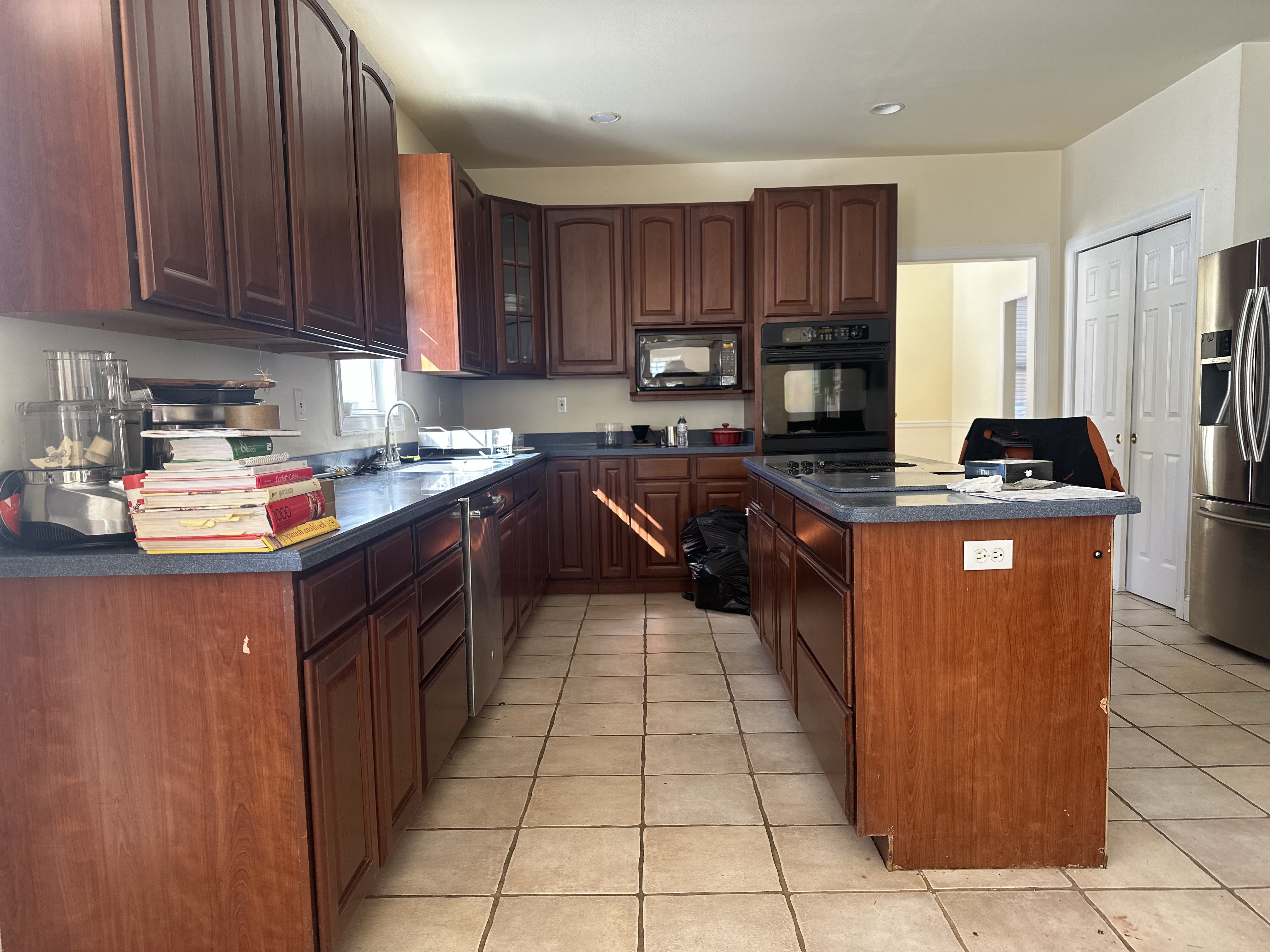 The Beverly kitchen before renovation, dated cherry cabinets and tile